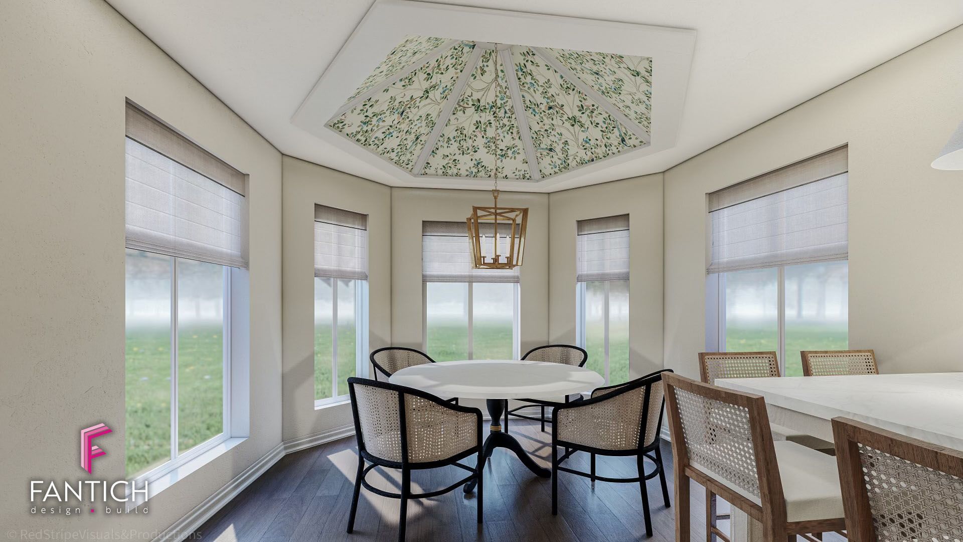 Bright dining nook with round table, black chairs, and large windows overlooking a green yard.