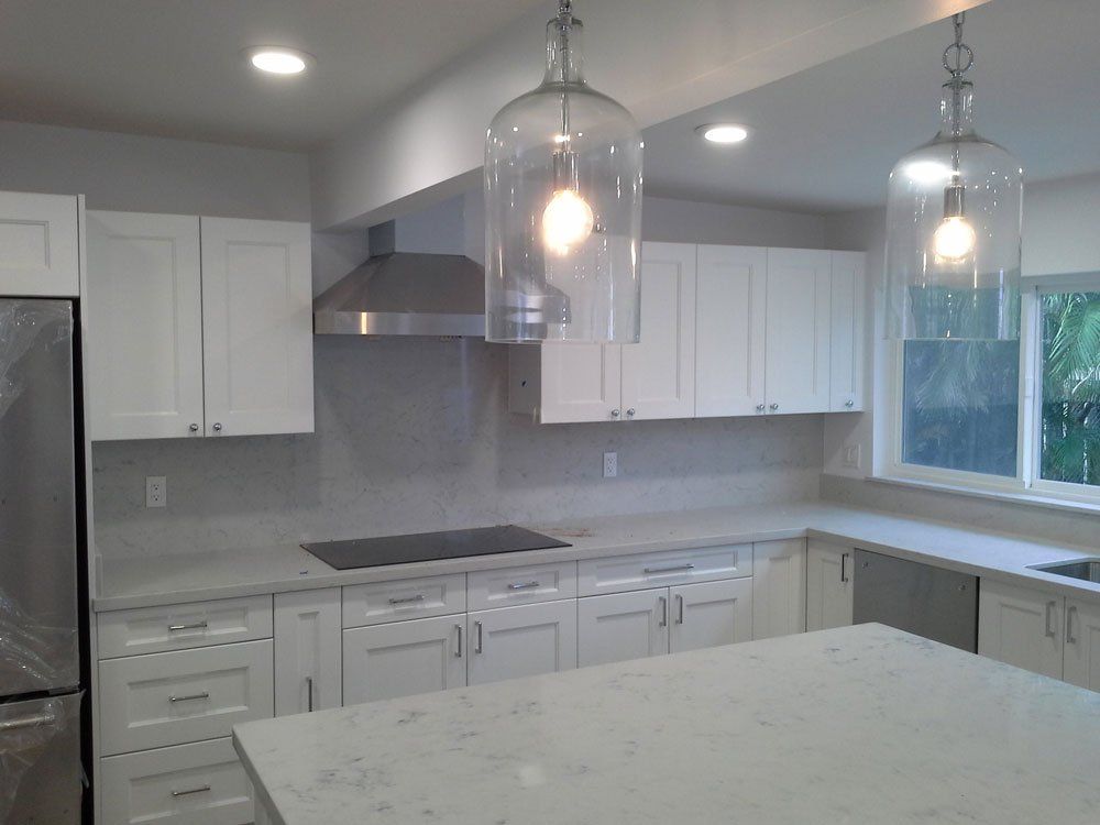 A kitchen with white cabinets and stainless steel appliances
