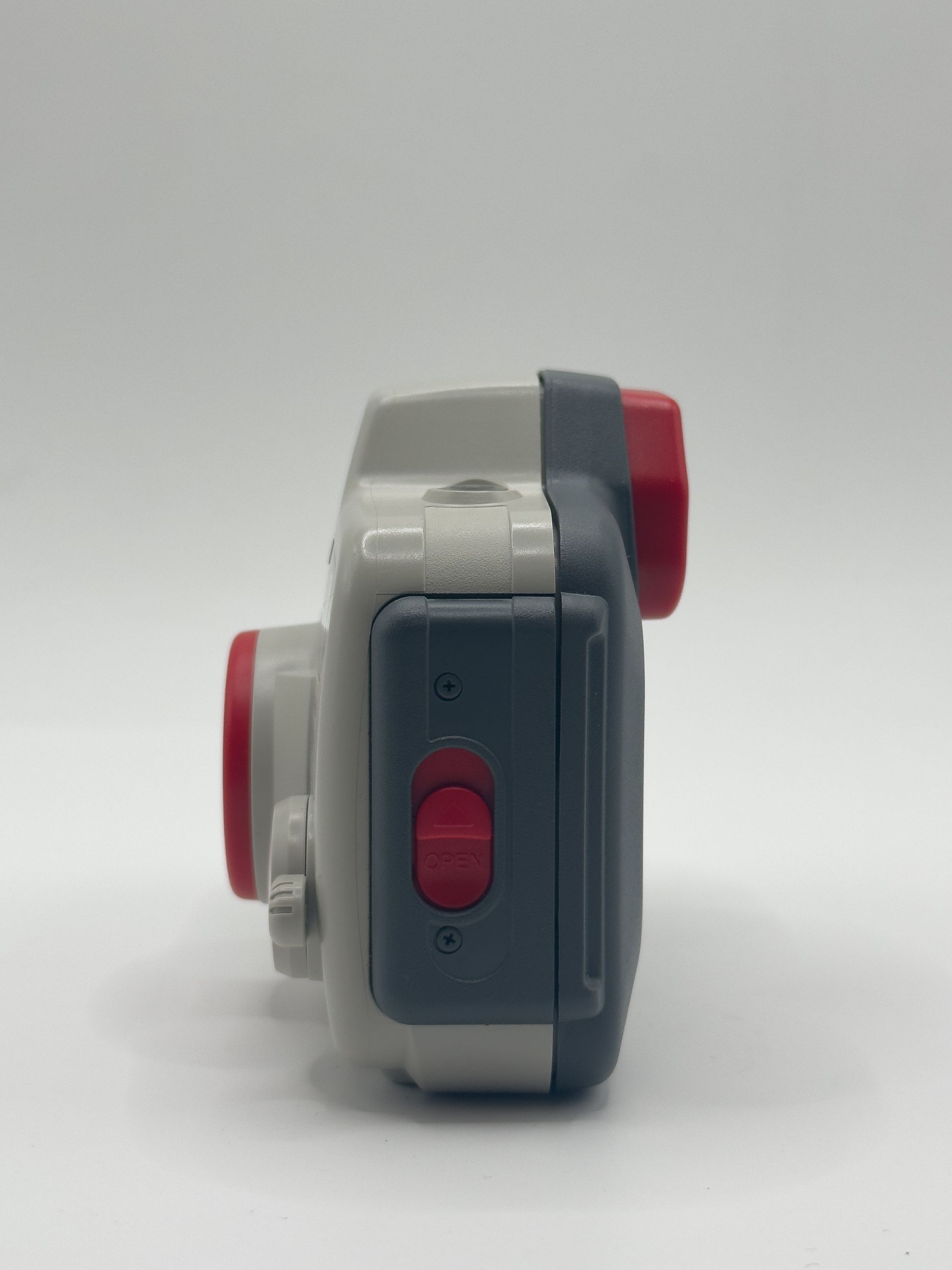 Canon Sure Shot film camera, silver with red accents, front view on white background