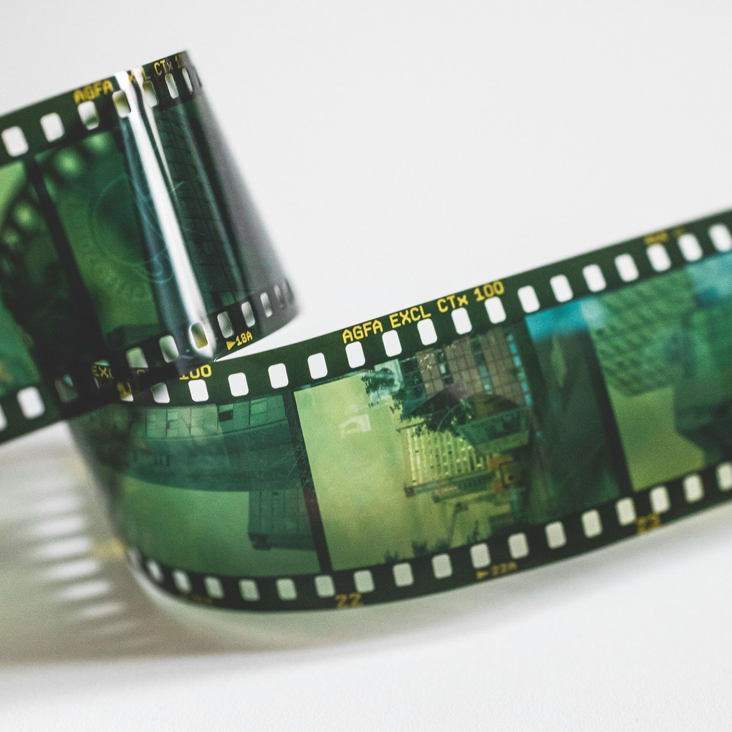 Vintage camera with detached film roll on a white background