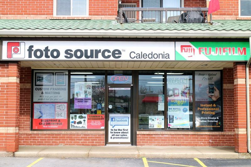 Storefront for Caledonia with Fujifilm signage and large front windows