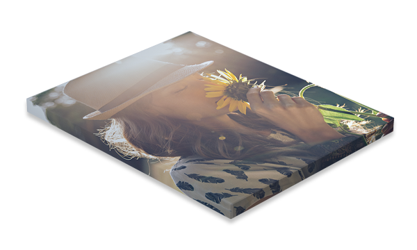 Stack of glossy photo prints with a sunflower on top and a spotted animal print underneath