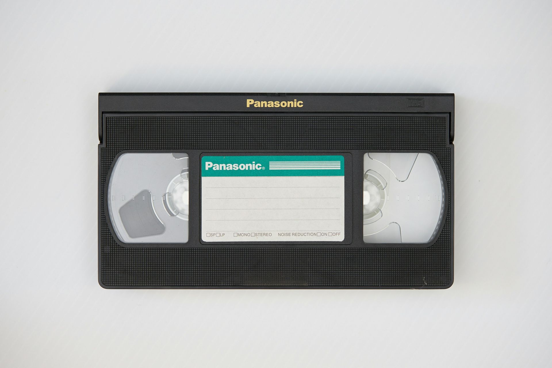 Panasonic VHS videotape with black casing and a gray label on a white background