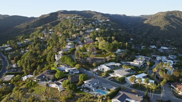 An aerial view of a residential area surrounded by mountains.