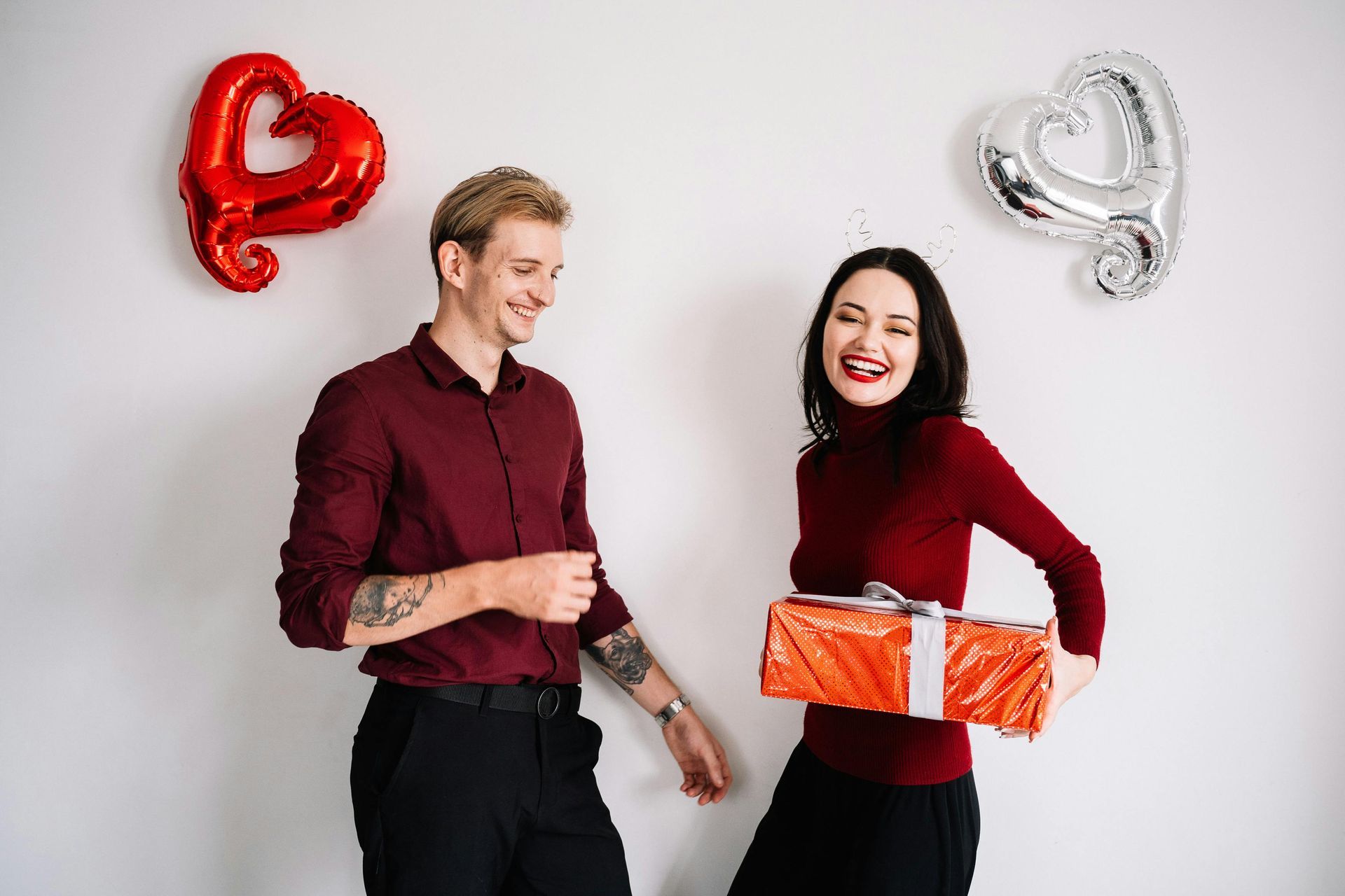 A man is giving a gift to a woman.