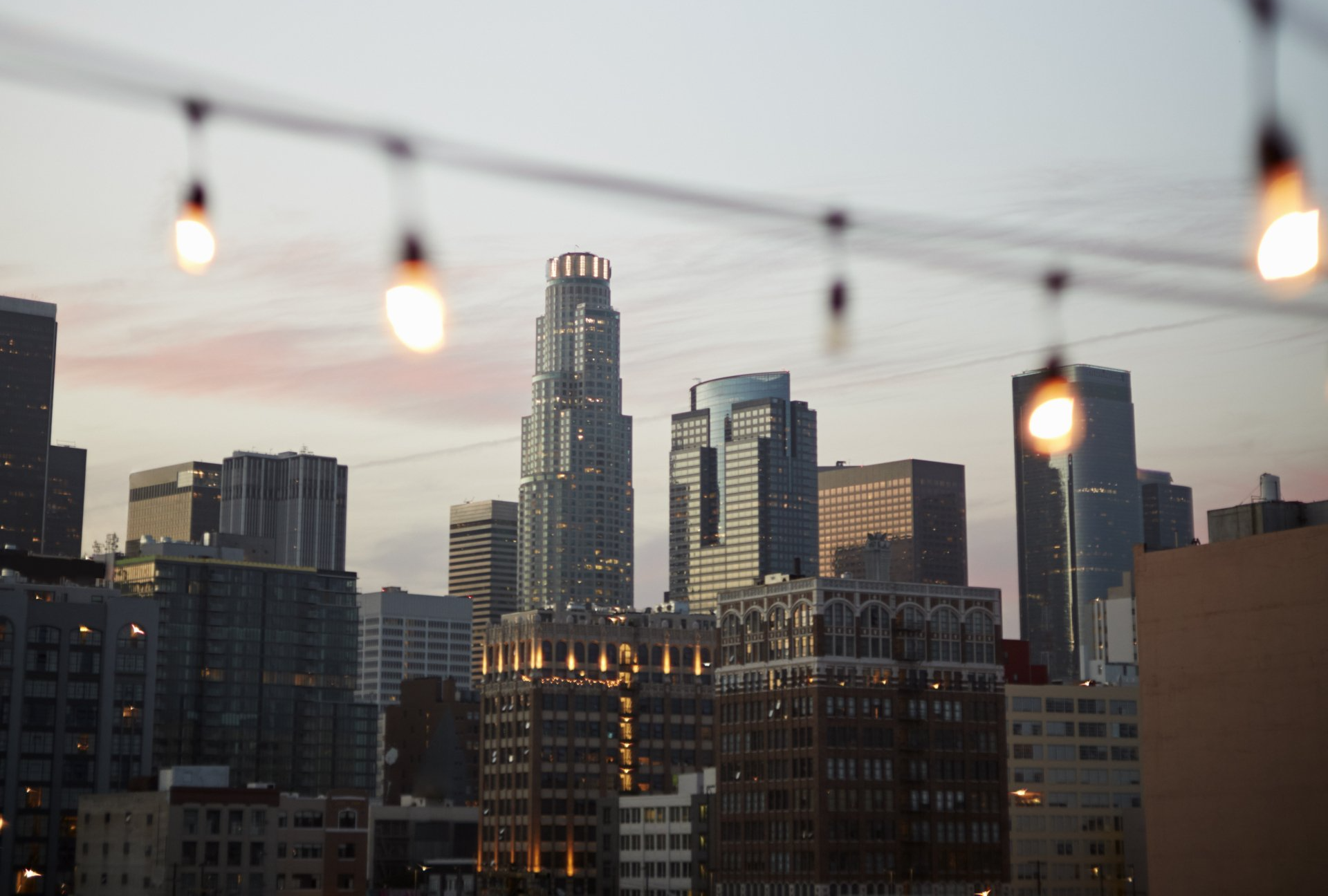 A city skyline with a string of lights in the foreground