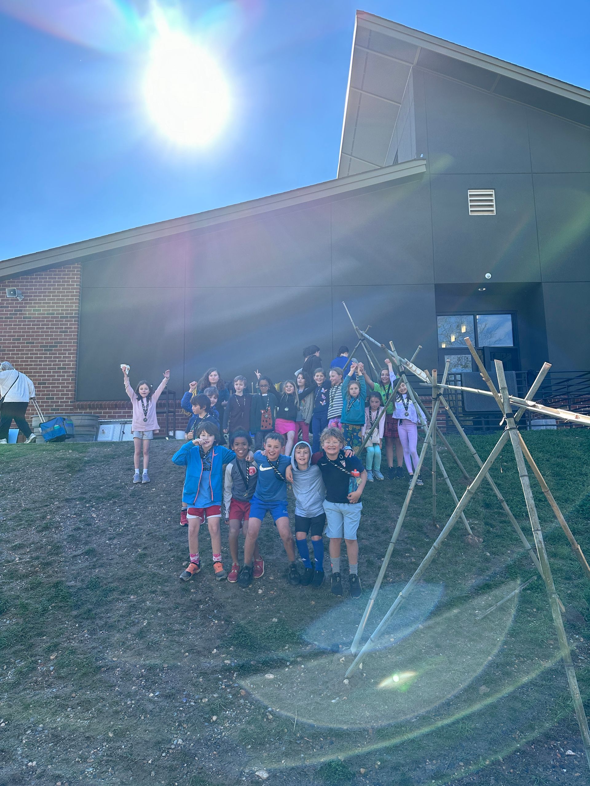 Students gather around an aqueduct that they made