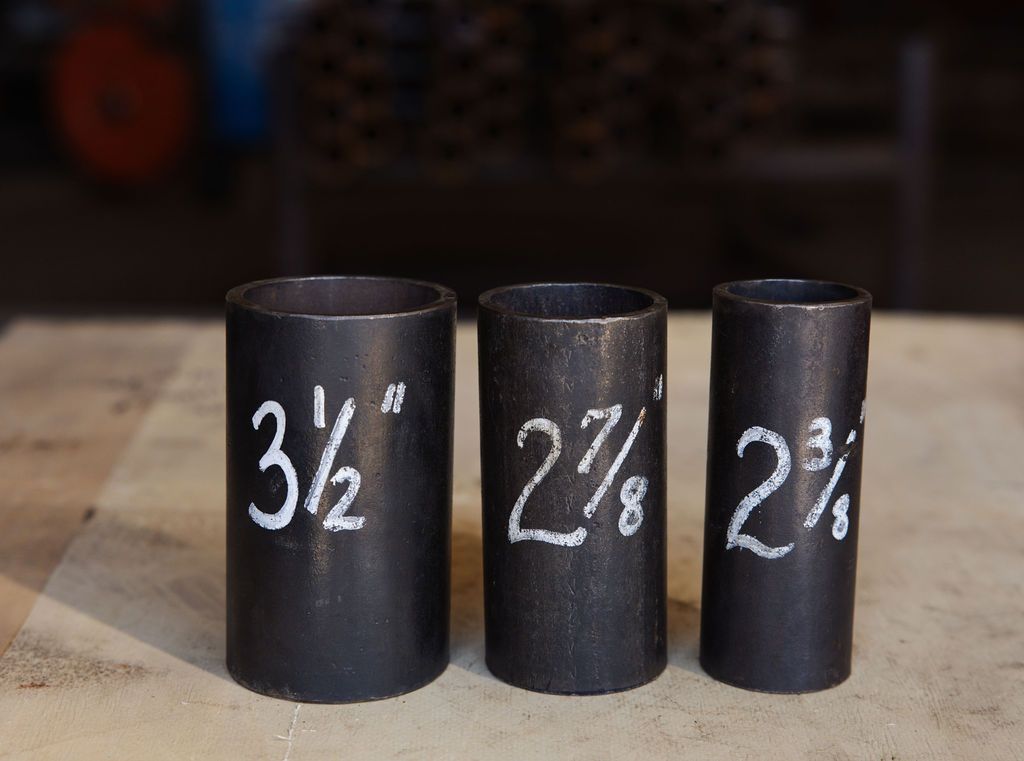 Three black sockets labeled 3/2, 2 7/8, and 2 3/4 on a wooden surface