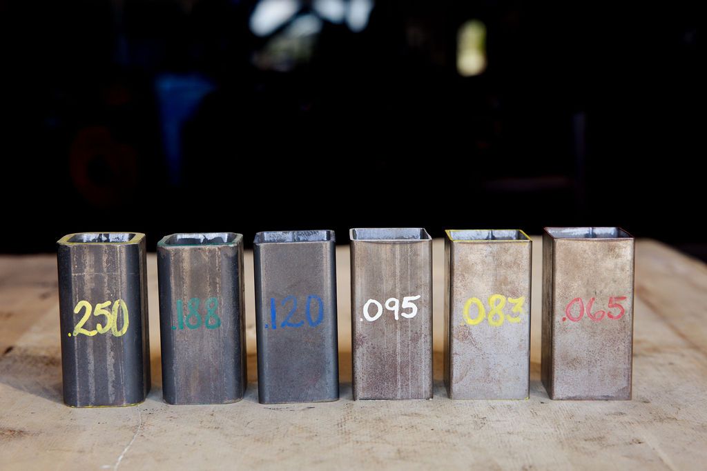 Six numbered metal blocks in a row on a tabletop, with dark blue, yellow, and white markings.