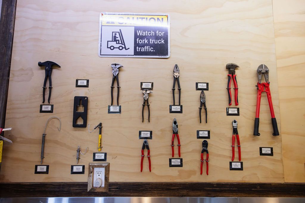 Wall display of hand fencing tools on wood