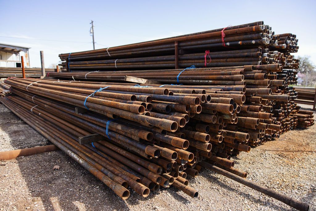 Stacked steel pipes in an outdoor storage yard