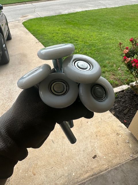 A person is holding a bunch of wheels in their hand.