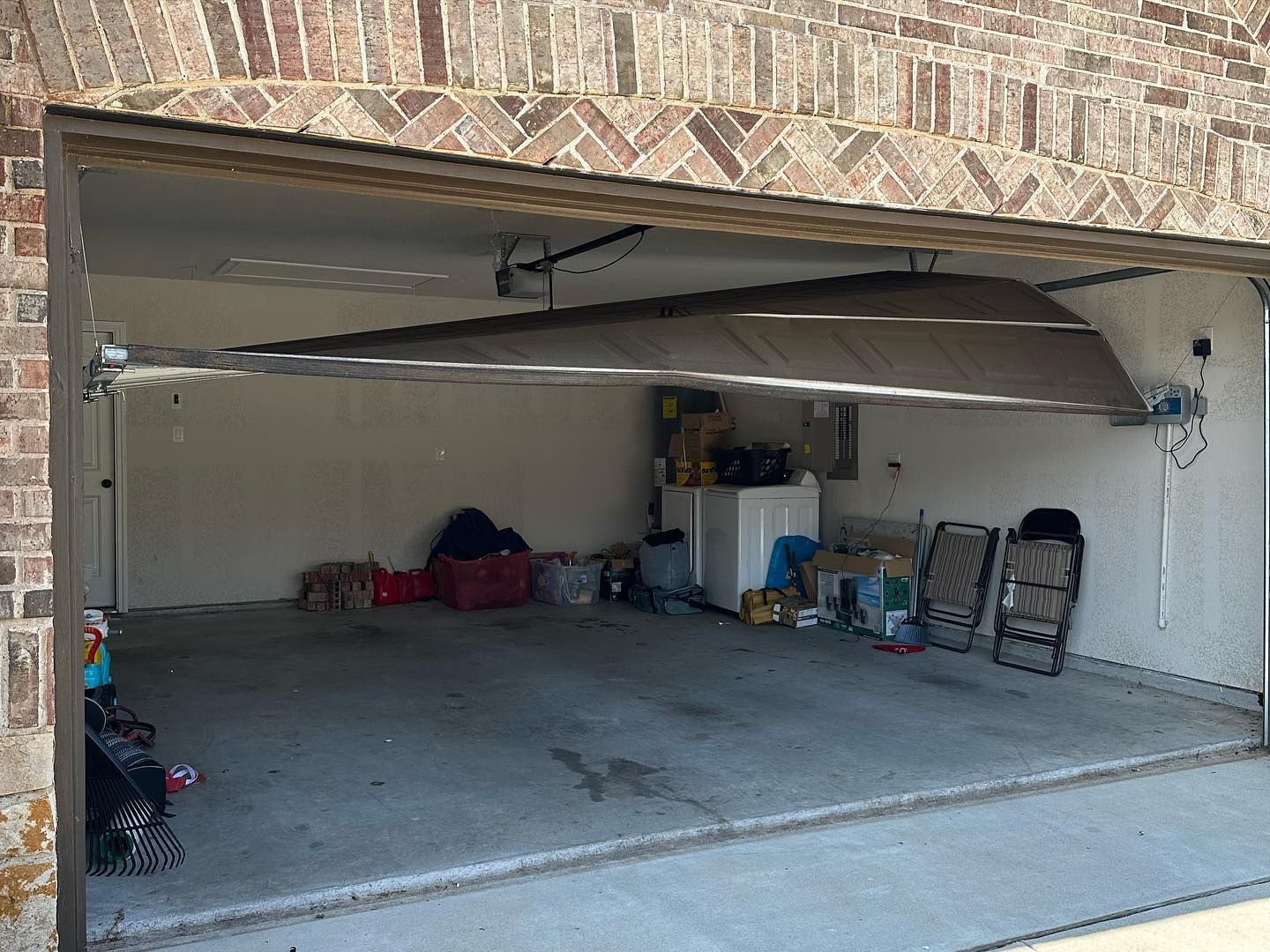 A garage with a canoe in it and a brick wall.