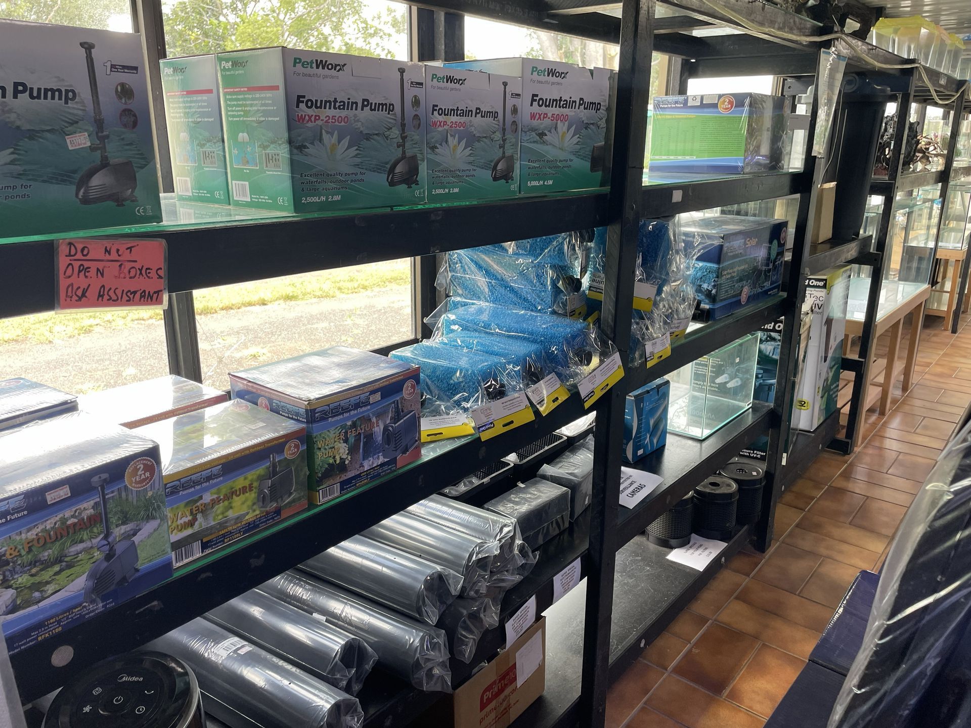 Shelves stocked with aquarium supplies in a store — Summerland Aquarium in Wollongbar, NSW