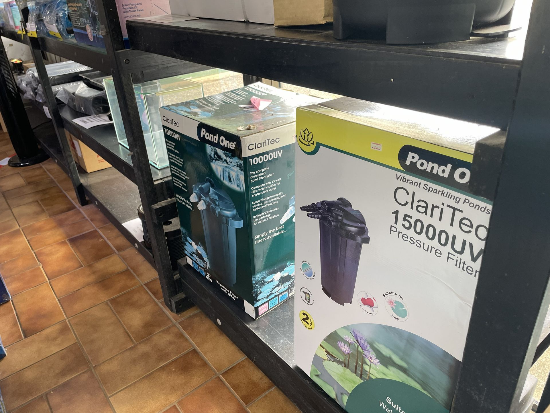 Shelves stocked with boxed pond filters in a store — Summerland Aquarium in Wollongbar, NSW