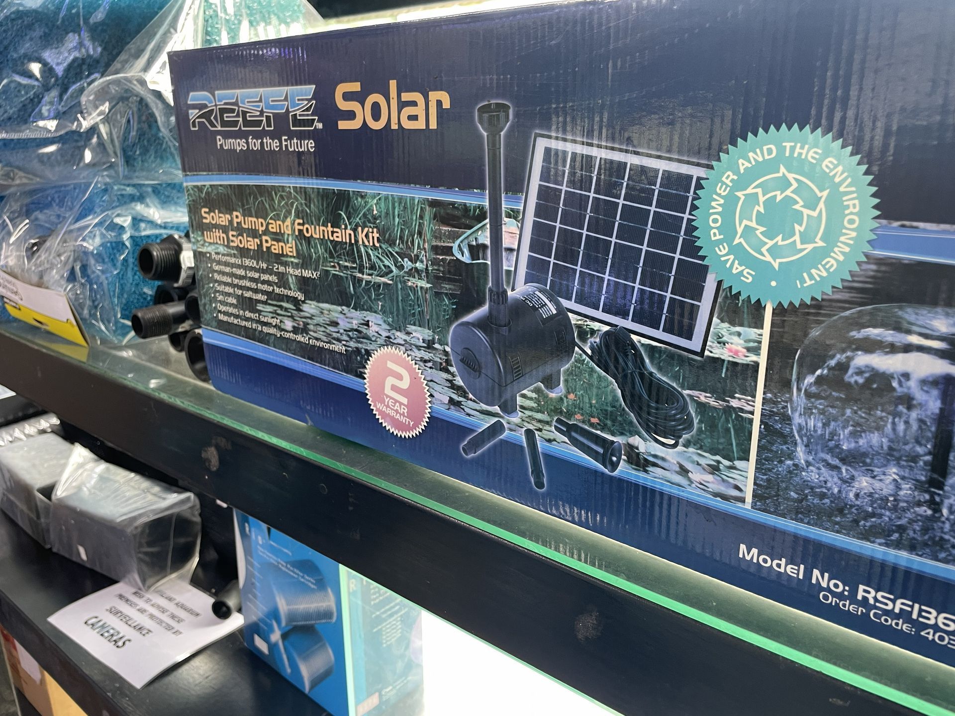 Box of a solar-powered water fountain, black pump and small solar panel on display — Summerland Aquarium in Wollongbar, NSW