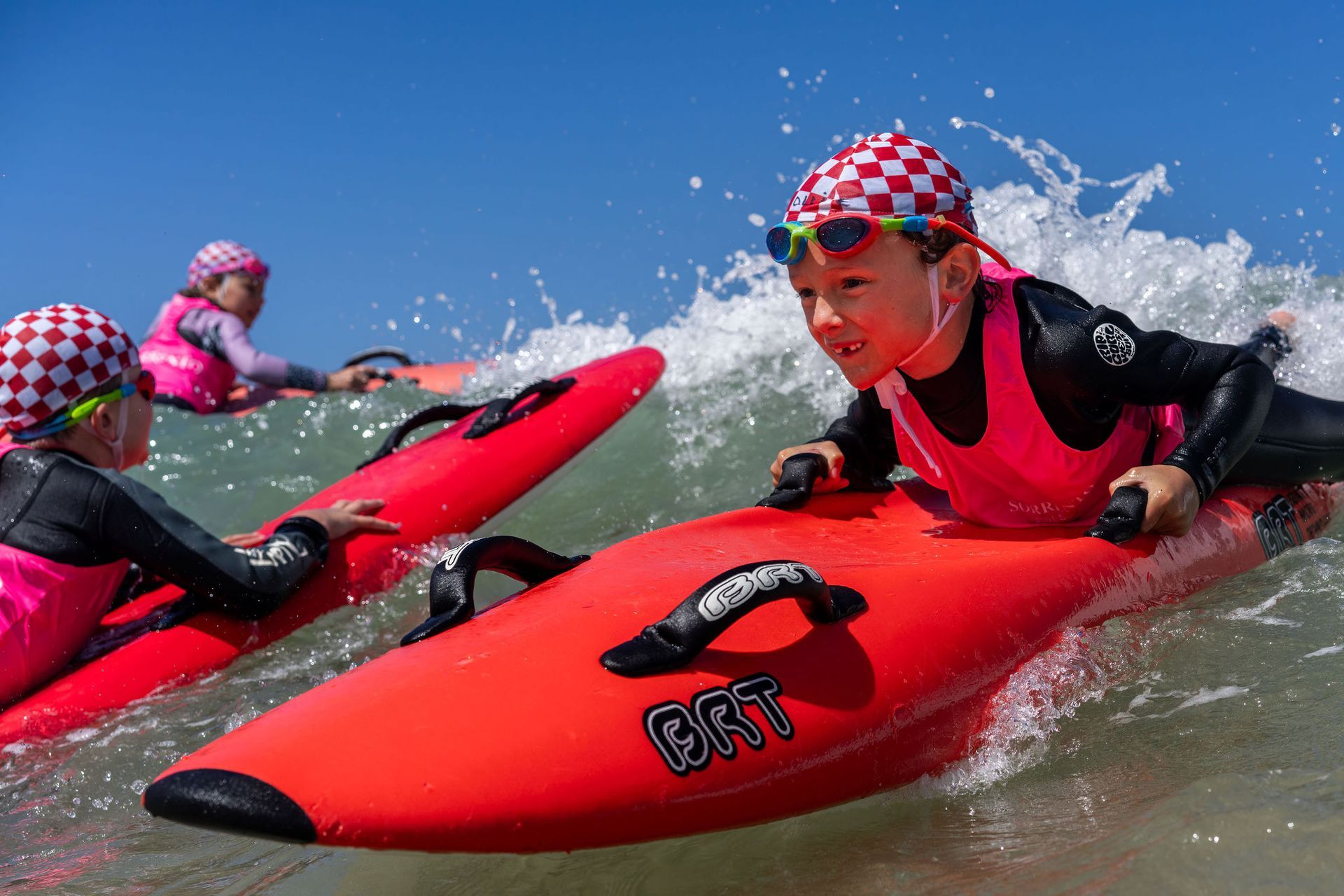 Nippers paddling boards through the waves