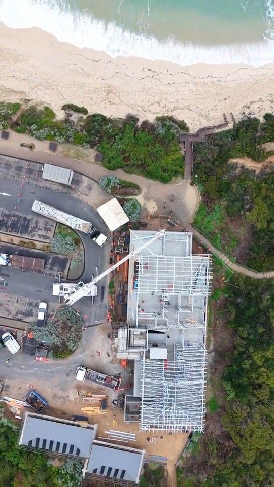 Aerial view of the clubhouse site showing the steel frame going up beside the beach car park.