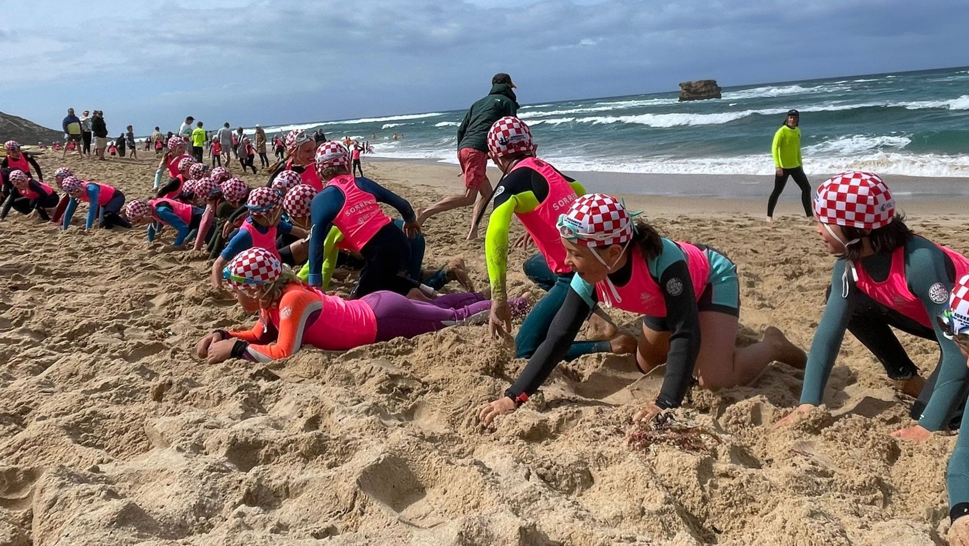 Nippers scrambling across the sand during a beach sprint at the end of season carnival.
