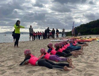 Nippers lying on rescue boards on the sand during a training drill.