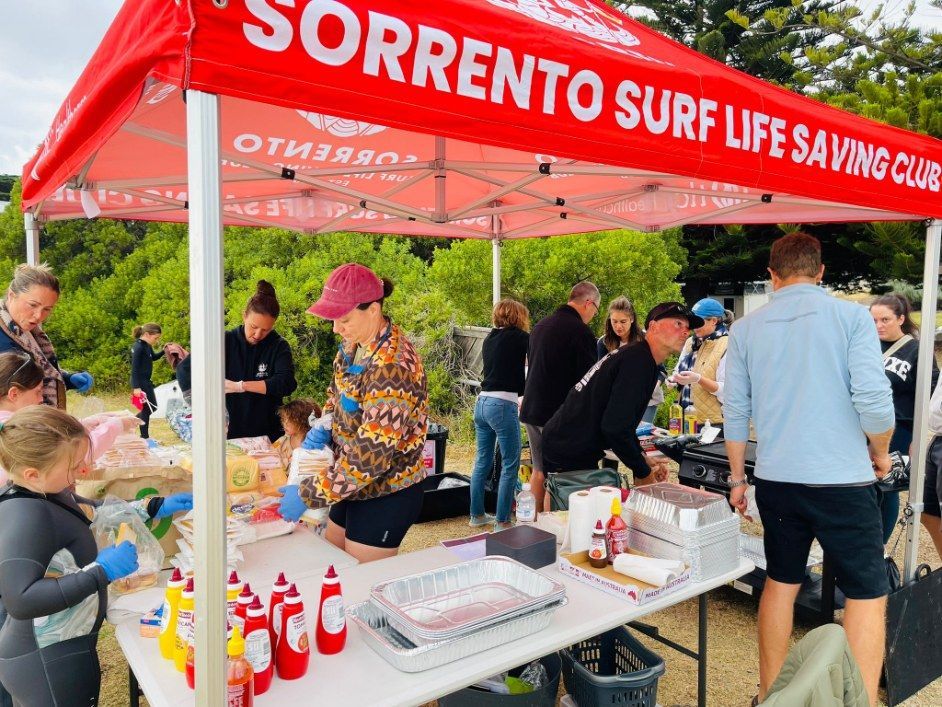 Volunteers serving from the Sorrento SLSC BBQ marquee.