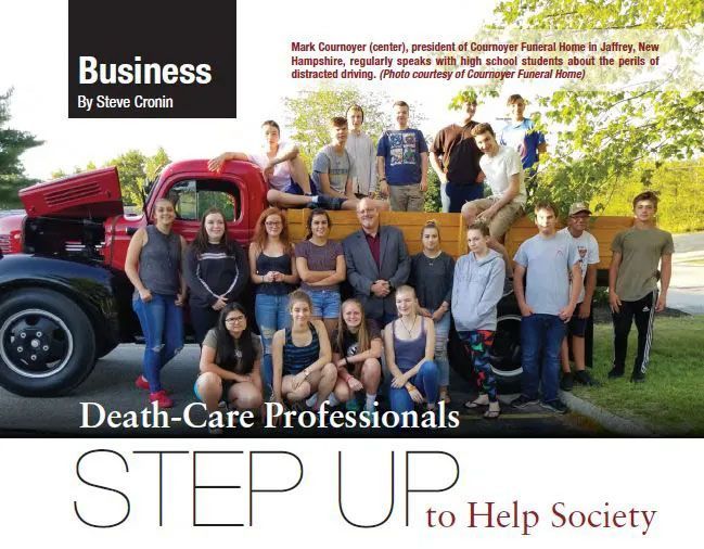 A group of people are posing for a picture in front of a truck.
