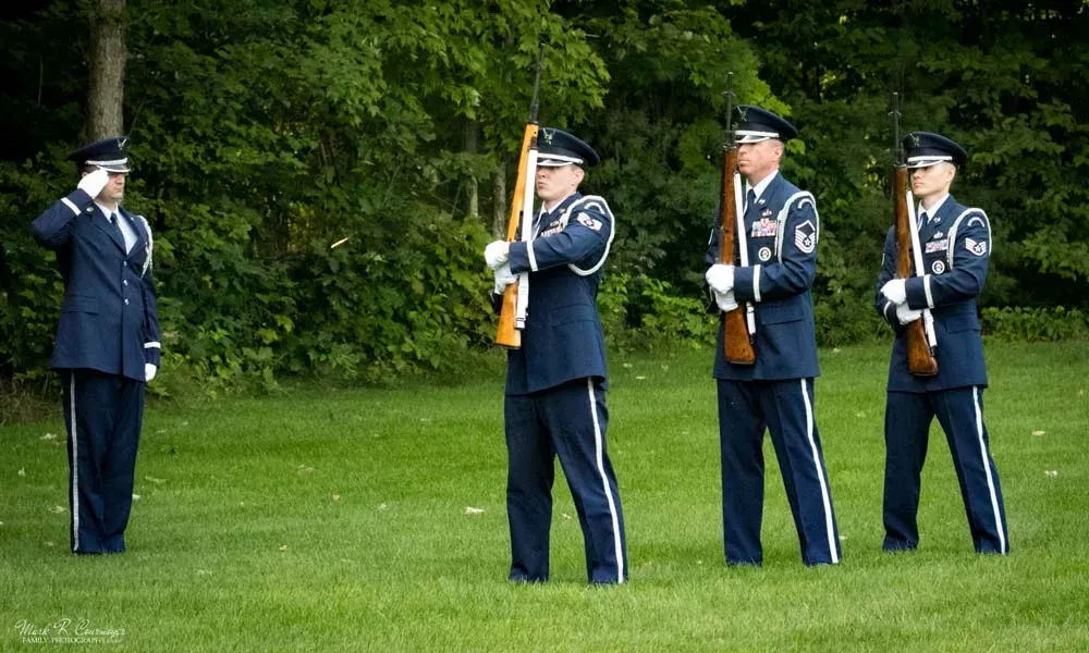 two veterans with rifles at a funeral