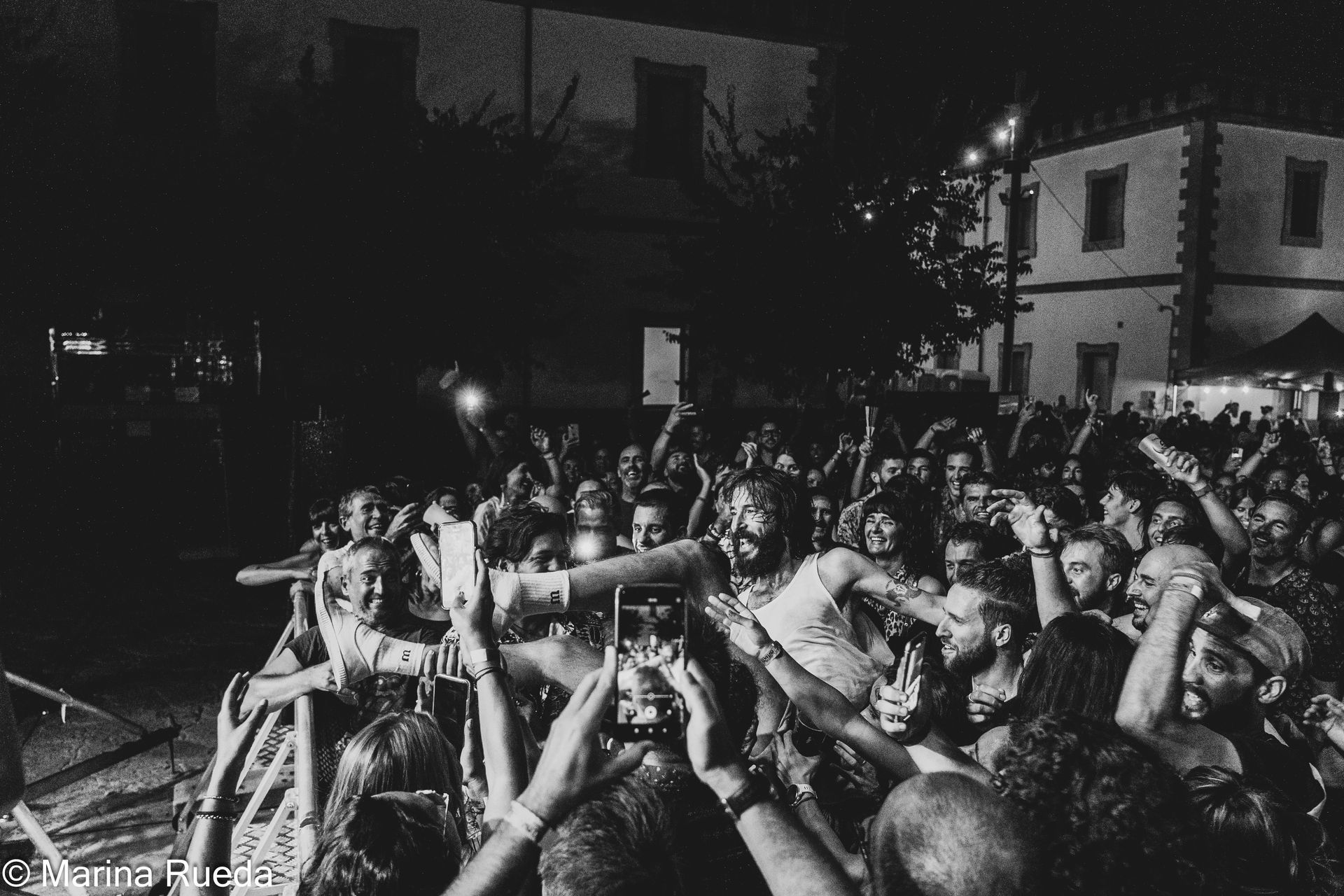 Una fotografía en blanco y negro de una multitud de personas en un concierto.
