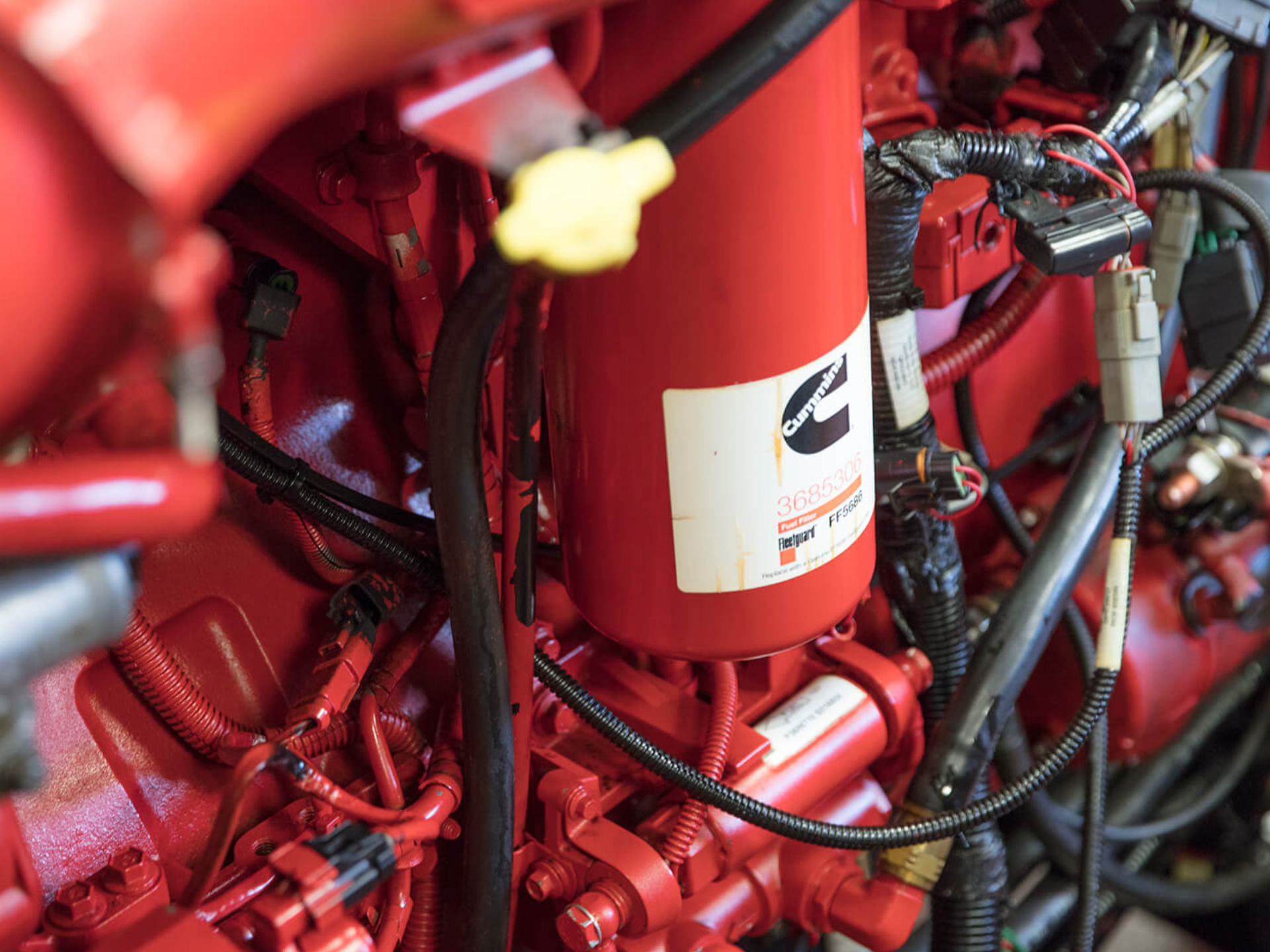 A close up of a red engine with a cummins logo on it.