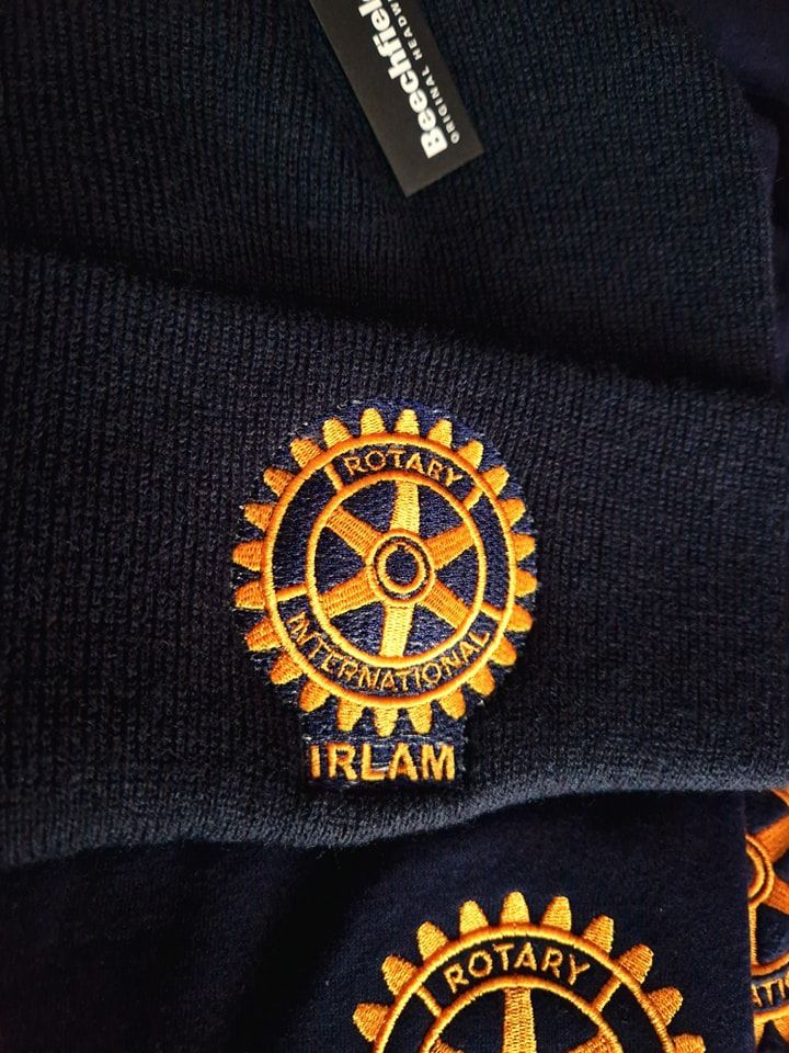 Navy blue beanie with embroidered gold Rotary International emblem and 