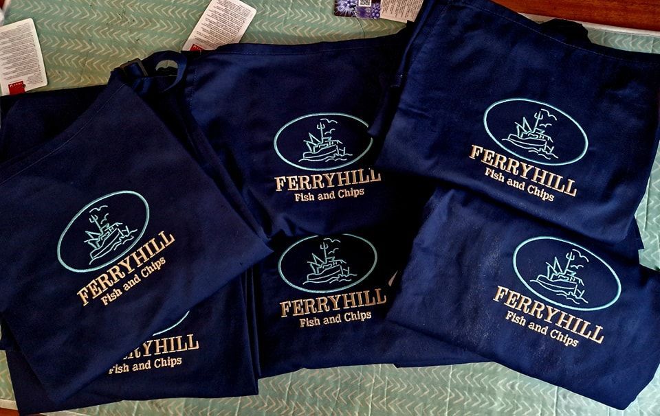 A bunch of perryhill shirts are sitting on a table