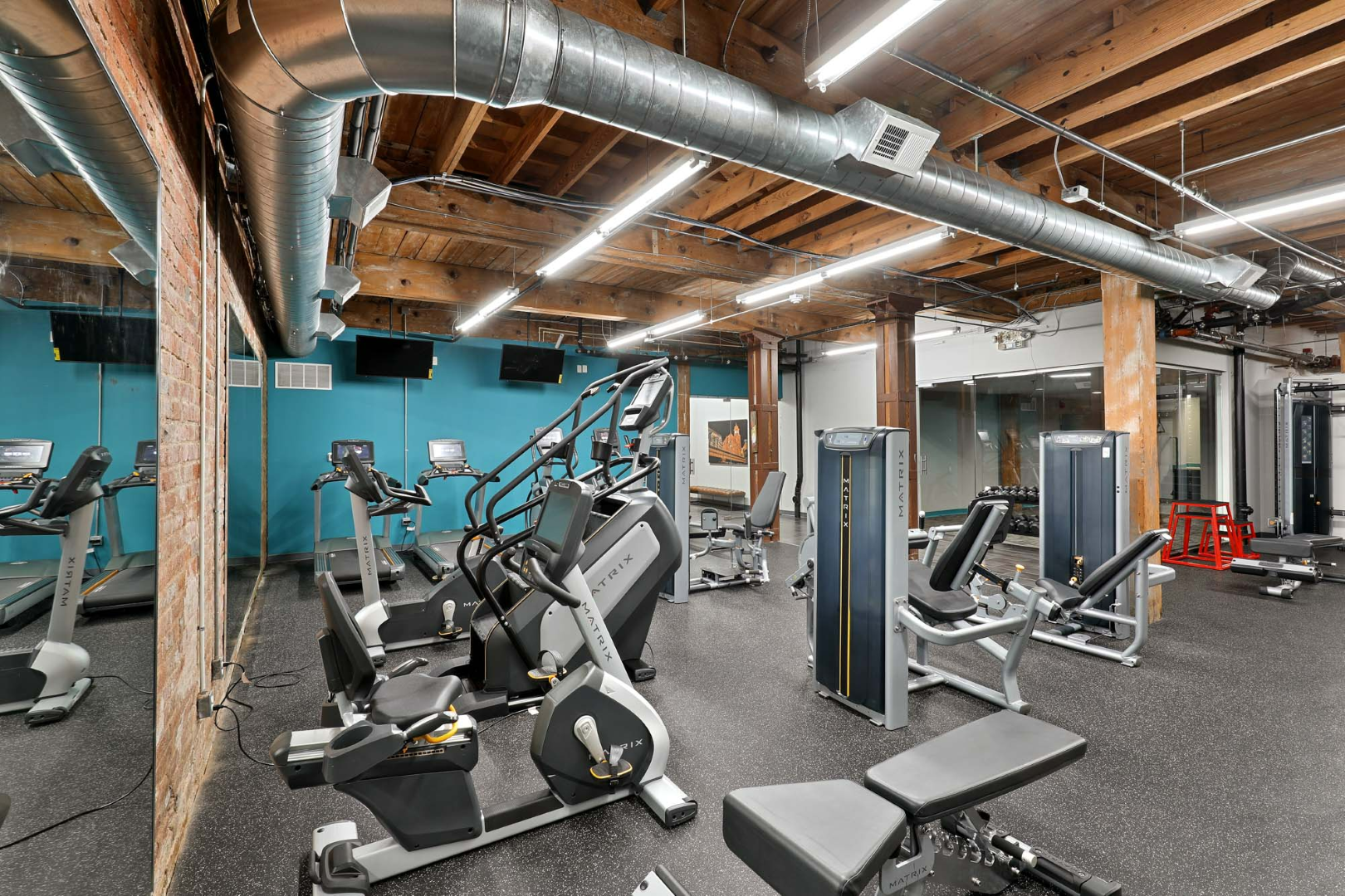 A large gym filled with lots of exercise equipment at The River Lofts at Tobacco Row offers apartments for rent in Richmond, VA.