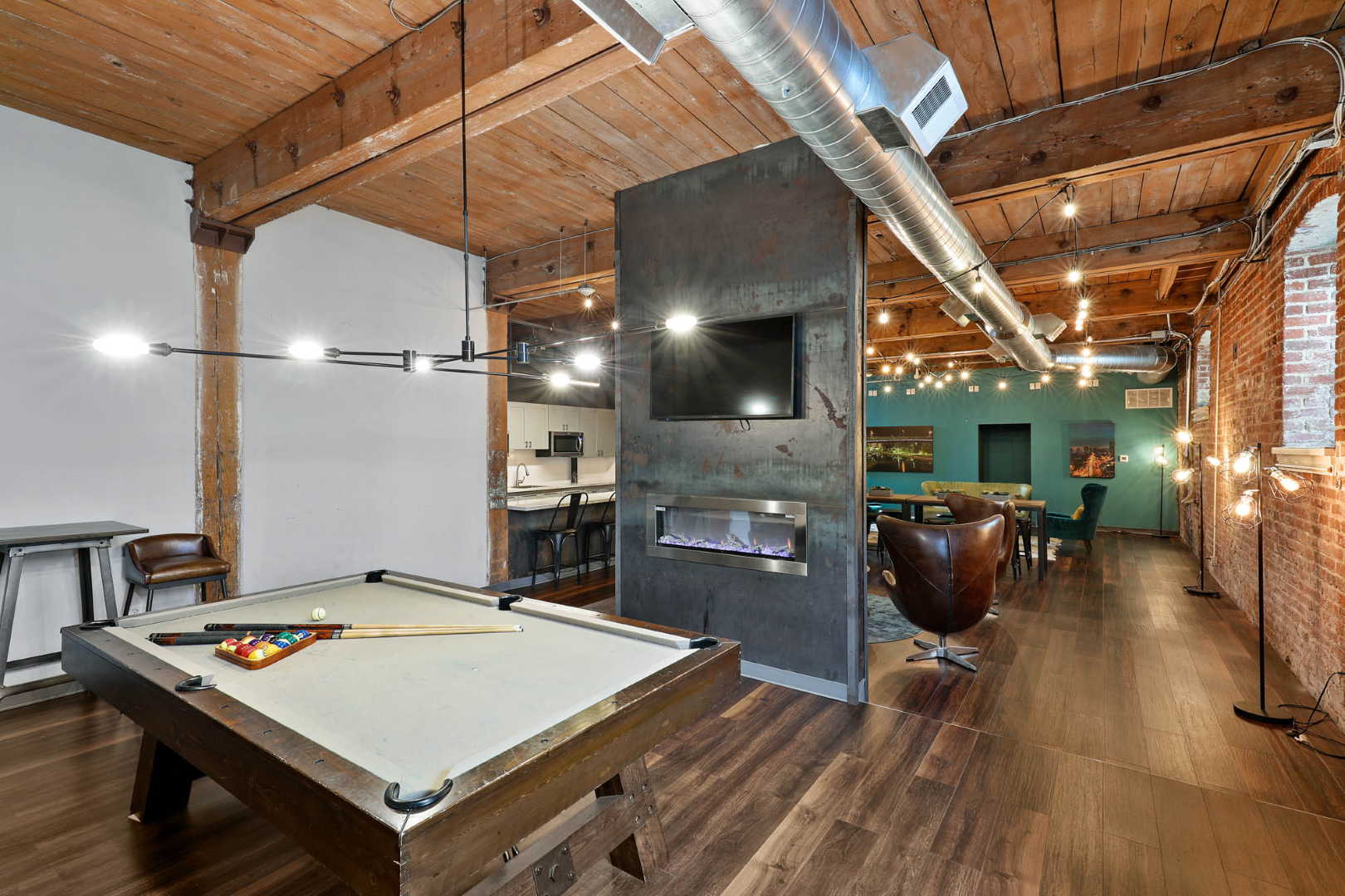 There is a pool table in the middle of the game room at the apartment clubhouse at The River Lofts at Tobacco Row in Richmond, VA.
