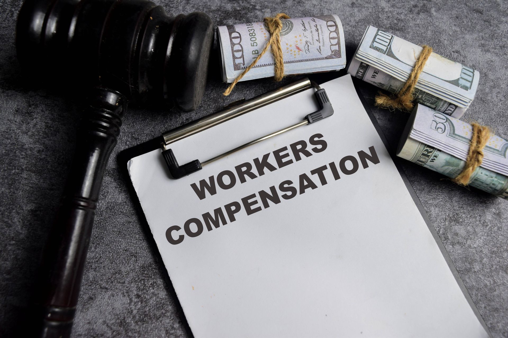 Concept of workers' compensation written on paperwork placed on a table. Concept of workers' compensation written on paperwork placed on a table.