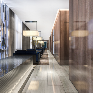 A long hallway with wooden walls and a couch