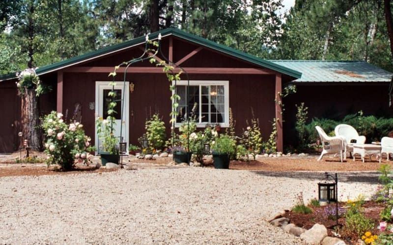 A house with a gravel driveway in front of it