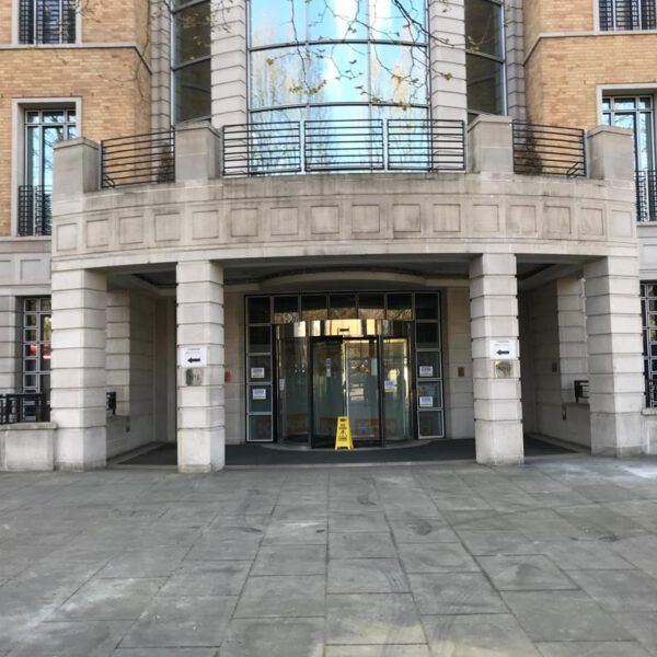 A large building with a yellow caution sign in front of it