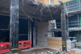 A building is being demolished in a construction site.