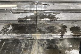 A close up of a metal surface with a lot of stains on it.