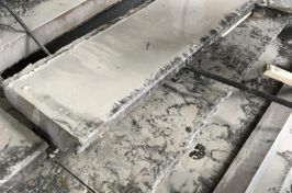 A close up of a marble counter top with a spatula.