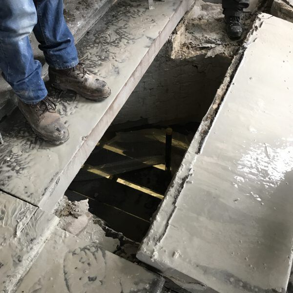 A person is standing in a hole in the floor