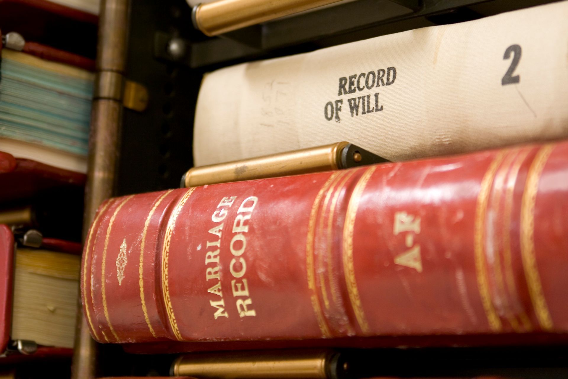 A stack of books including a marriage record and a record of will