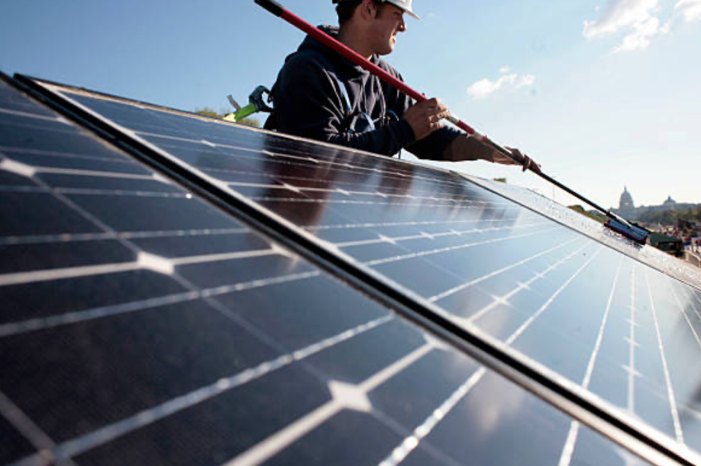 a man cleaning solar panels