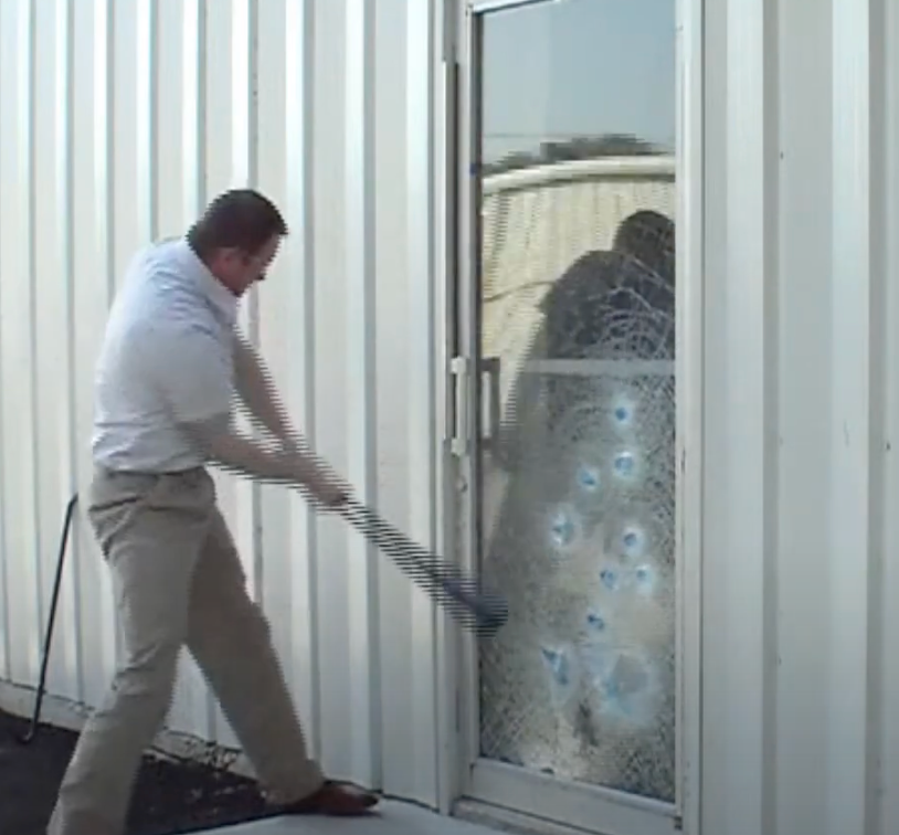 a photo of a man breaking a glass door