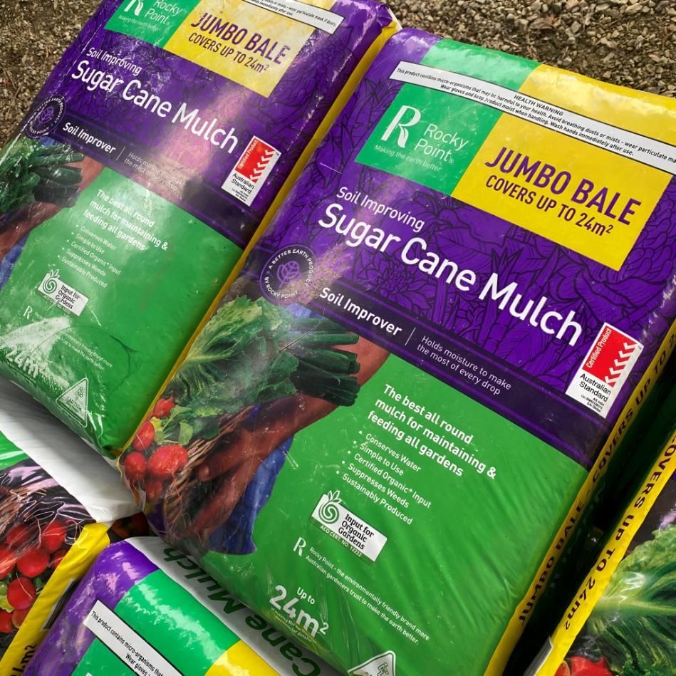 Several Bags of Sugar Cane Mulch Are Stacked on Top of Each Other — Black Rock Garden Centre In Tyagarah, NSW