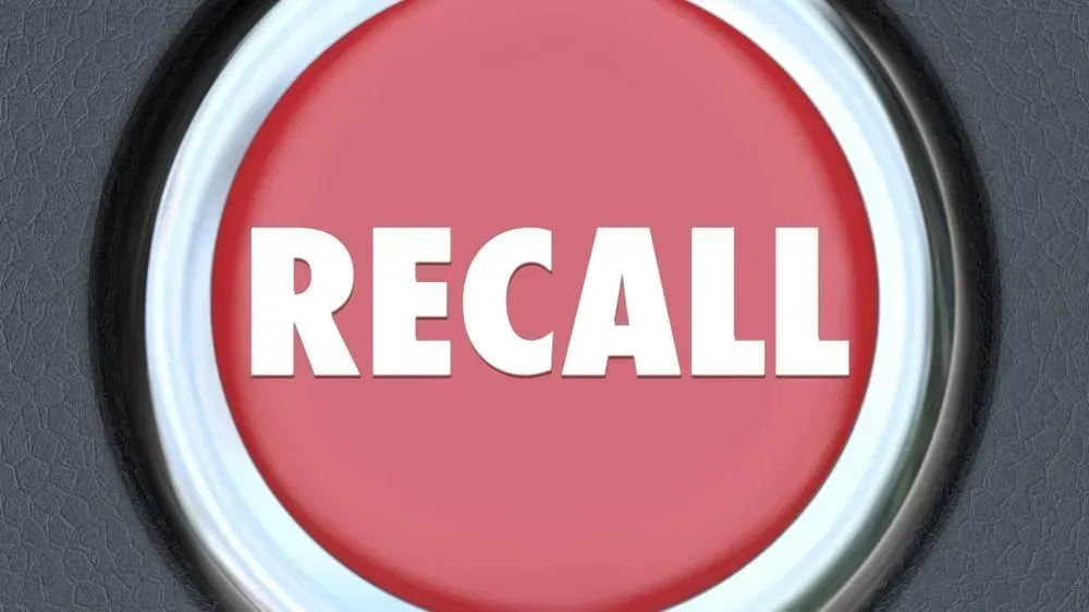 A red button with the word recall on it