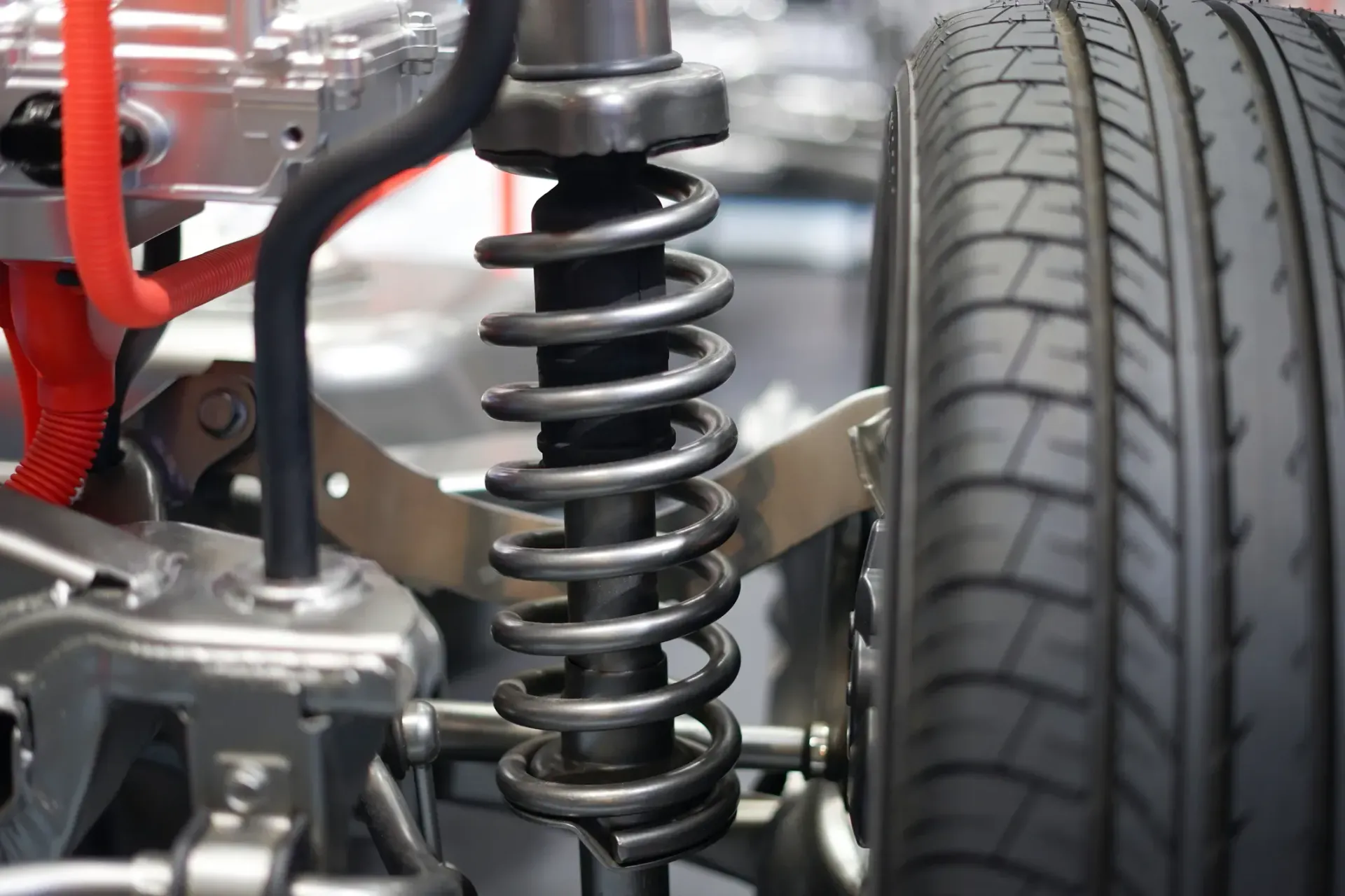 A woman is working on a car engine with a wrench.