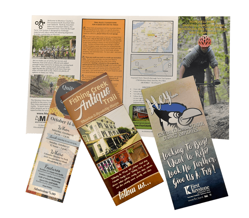 A fishing creek antique trail pamphlet is on a table with other pamphlets by Press Enterprise Commercial Printing