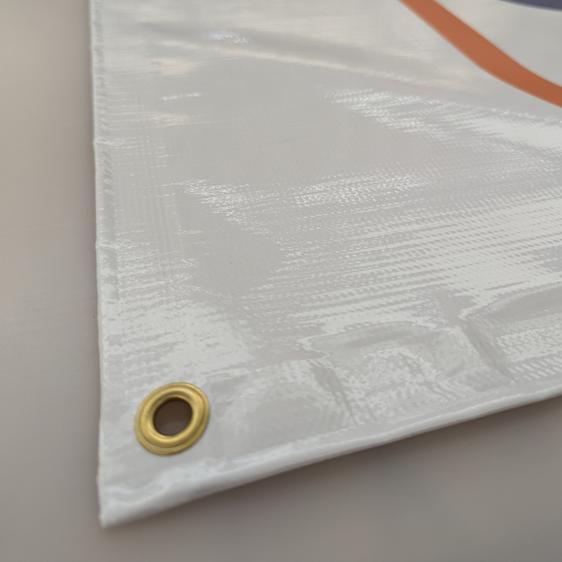 A close up of a white tarp with a hole in the middle by Press Enterprise Commercial Printing