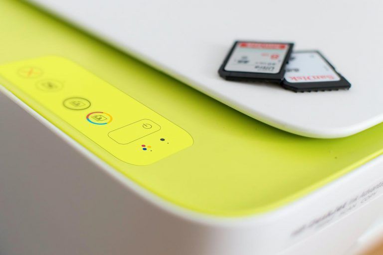 A close up of a printer with two sd cards on top of it. A close up of a printer with two sd cards on top of it.